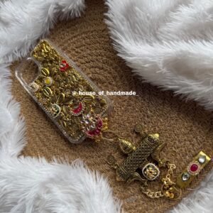 Golden oxidise phone case with some kundan and juda pin