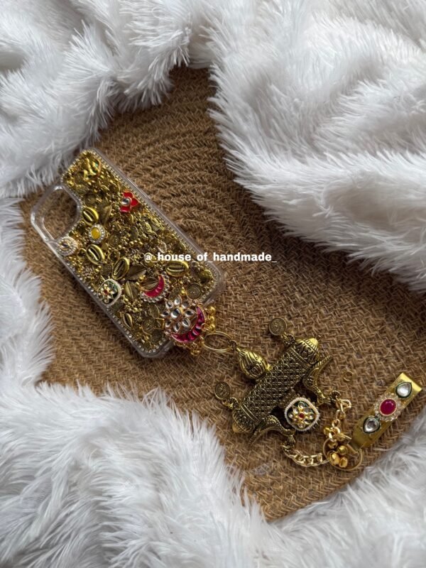 Golden oxidise phone case with some kundan and juda pin